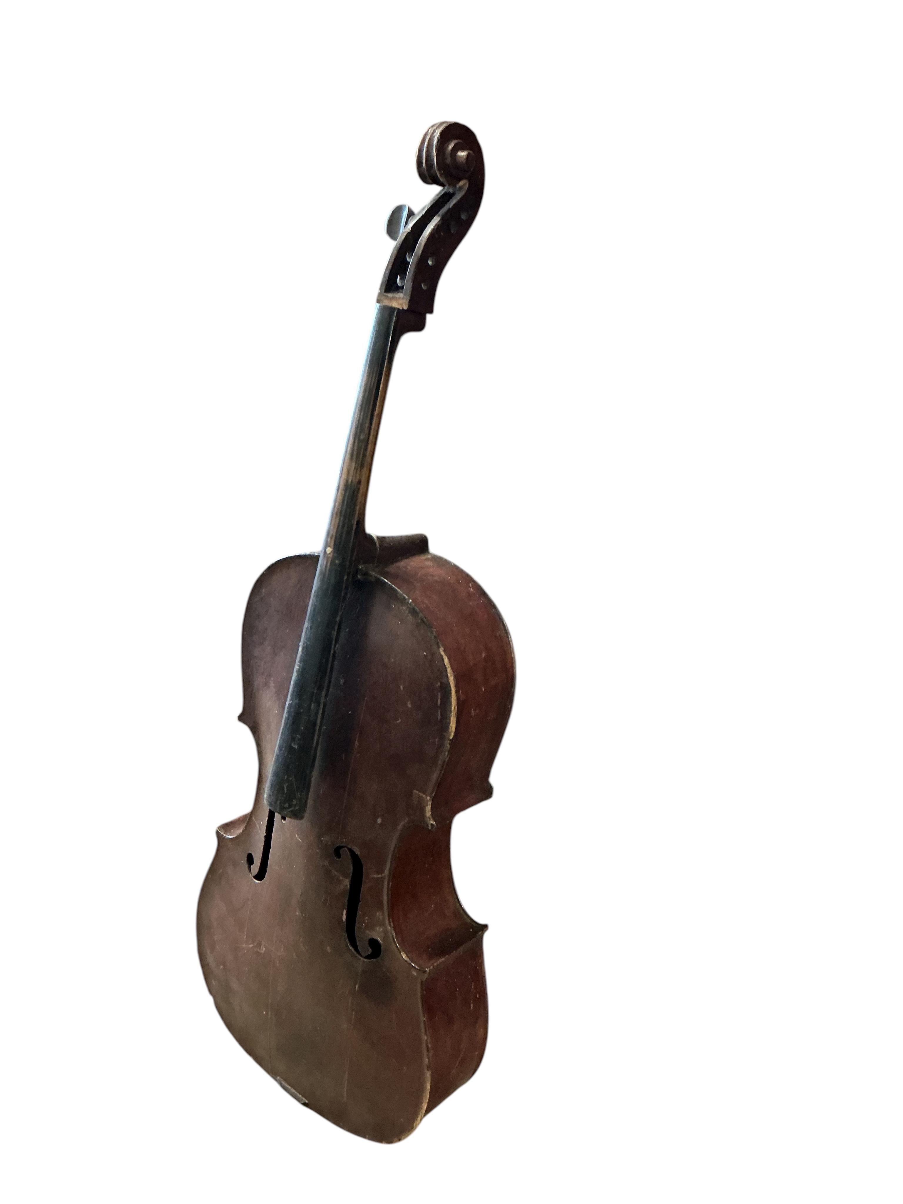 A small cello and assorted instruments in need of restoration